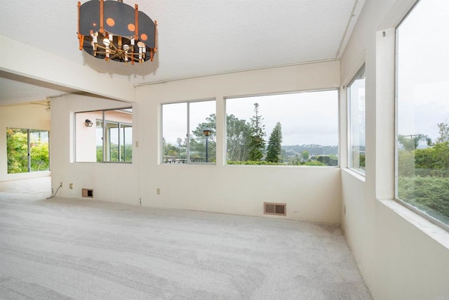 557 Canyon Dr, Solana Beach, CA 92075 - unfurnished sunroom with plenty of natural light, carpet, and a chandelier