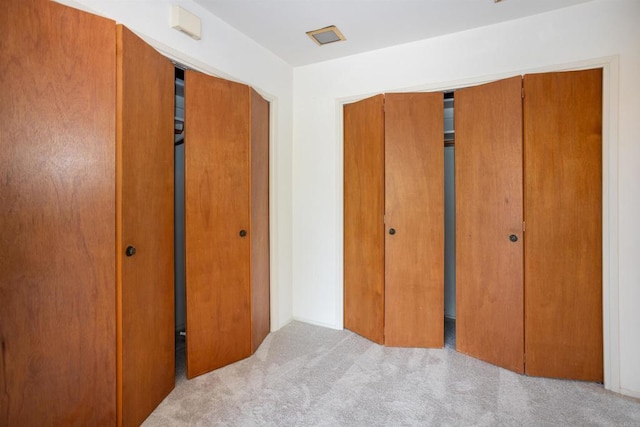 557 Canyon Dr, Solana Beach, CA 92075 - unfurnished bedroom featuring carpet flooring and two closets