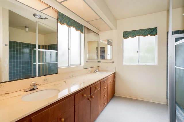 557 Canyon Dr, Solana Beach, CA 92075 - full bathroom with double vanity, tiled shower, and baseboards