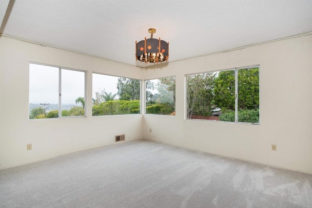 557 Canyon Dr, Solana Beach, CA 92075 - carpeted empty room featuring a chandelier and a textured ceiling