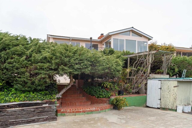 557 Canyon Dr, Solana Beach, CA 92075 - view of front of property with stairs, a shed, an outdoor structure, and a patio area