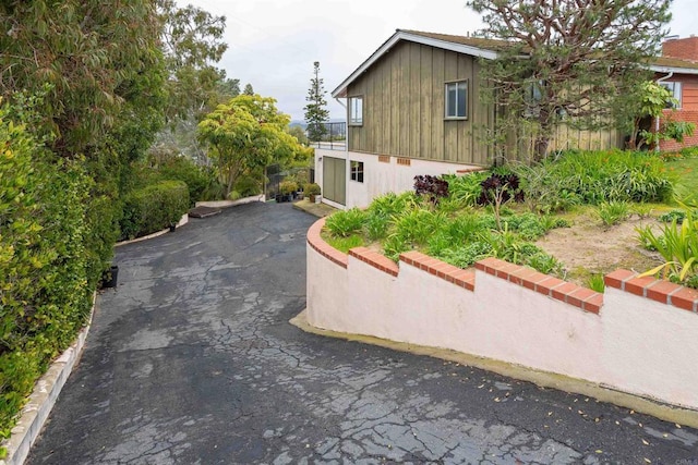 557 Canyon Dr, Solana Beach, CA 92075 - view of side of property with board and batten siding and driveway