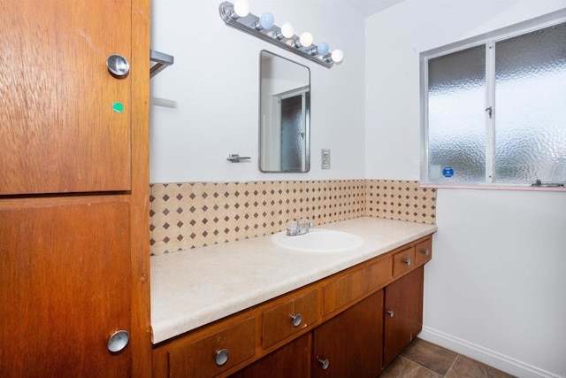 557 Canyon Dr, Solana Beach, CA 92075 - bathroom featuring backsplash, vanity, baseboards, and tile patterned flooring