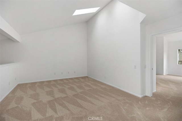 additional living space with a skylight, carpet floors, and baseboards