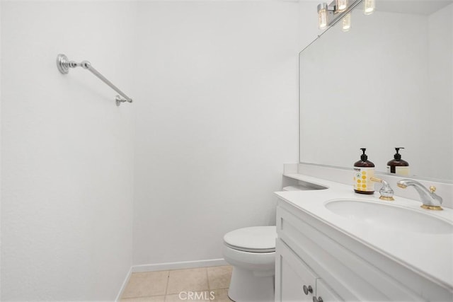 bathroom with toilet, baseboards, tile patterned flooring, and vanity