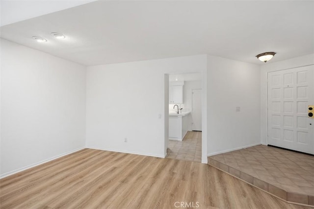 interior space with light wood-style floors and baseboards