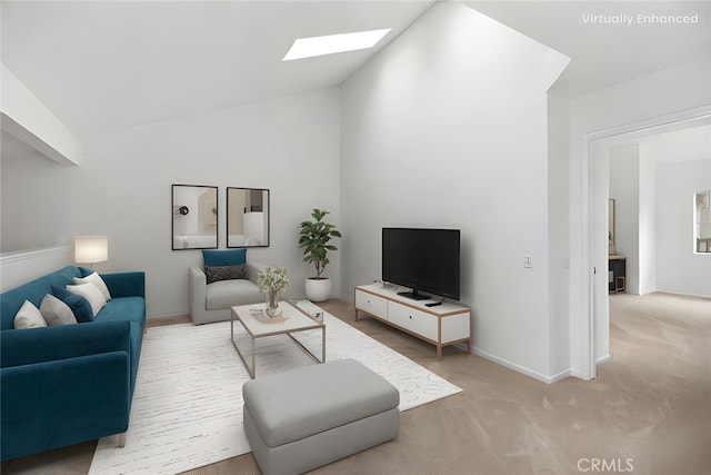 living area with baseboards, light colored carpet, and lofted ceiling with skylight