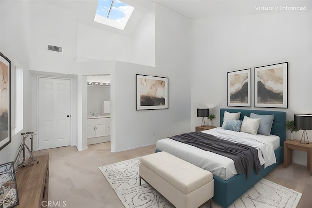 bedroom featuring a sink, ensuite bath, high vaulted ceiling, a skylight, and visible vents