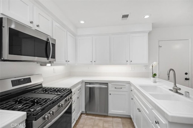 kitchen featuring white cabinets, stainless steel appliances, and a sink