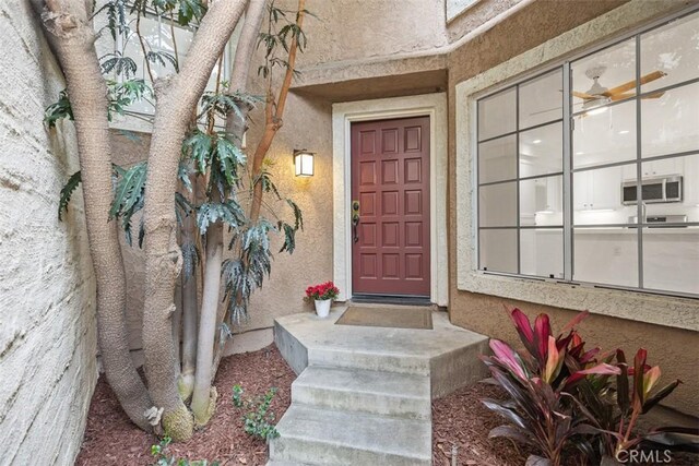 property entrance with stucco siding