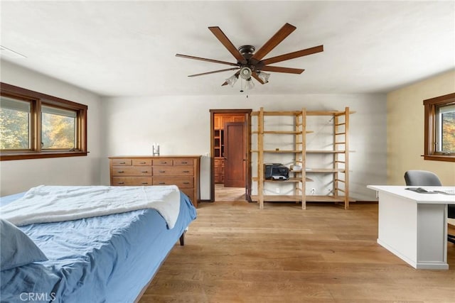 12352 Centerville Rd, Chico, CA 95928 - bedroom featuring an office area, light wood-style floors, multiple windows, and a ceiling fan
