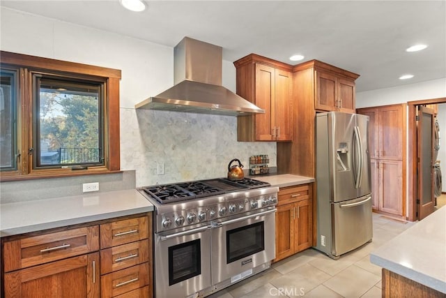 12352 Centerville Rd, Chico, CA 95928 - kitchen with appliances with stainless steel finishes, wall chimney exhaust hood, recessed lighting, light countertops, and brown cabinetry