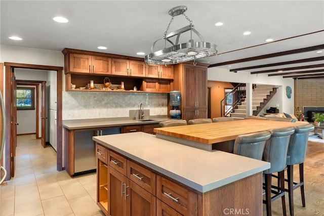 12352 Centerville Rd, Chico, CA 95928 - kitchen with open shelves, a kitchen island, a breakfast bar area, brown cabinetry, and recessed lighting