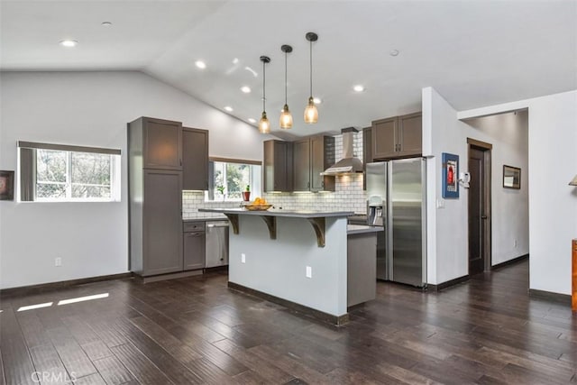 2447 Stonyvale Rd, Tujunga, CA 91042 - kitchen with stainless steel appliances, wall chimney exhaust hood, a breakfast bar, a kitchen island, and tasteful backsplash