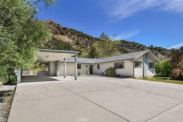 2447 Stonyvale Rd, Tujunga, CA 91042 - view of front of house featuring driveway, stucco siding, and a carport