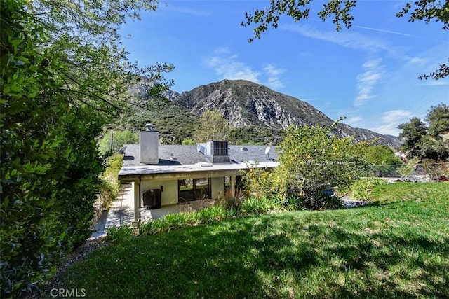 2447 Stonyvale Rd, Tujunga, CA 91042 - back of property featuring a mountain view, a yard, a chimney, and a patio