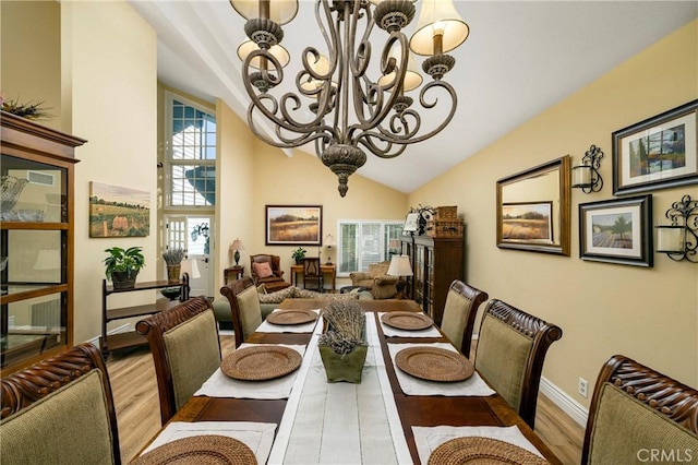 1 Champlain, Irvine, CA 92620 - dining space featuring baseboards, high vaulted ceiling, an inviting chandelier, and wood finished floors