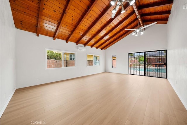 unfurnished living room with wooden ceiling, plenty of natural light, ceiling fan, beam ceiling, and a wall unit AC