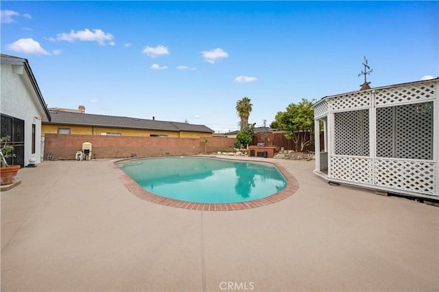 view of swimming pool featuring a fenced backyard, a fenced in pool, and a patio