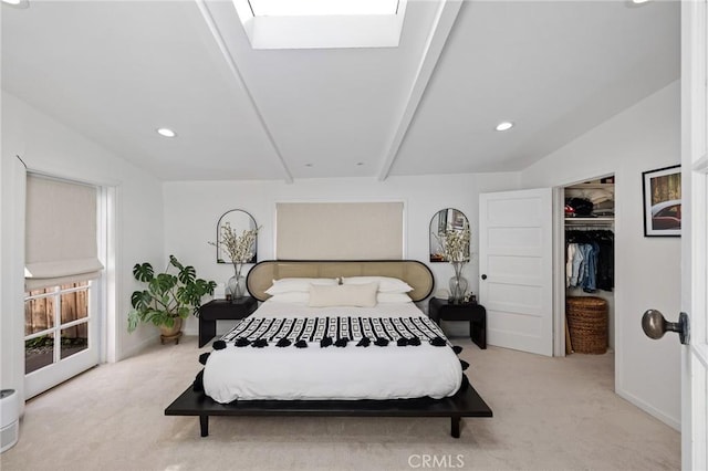 bedroom featuring a closet, light carpet, a skylight, a walk in closet, and recessed lighting
