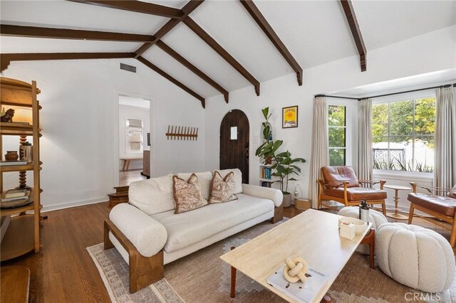living room featuring lofted ceiling with beams, wood finished floors, baseboards, visible vents, and arched walkways