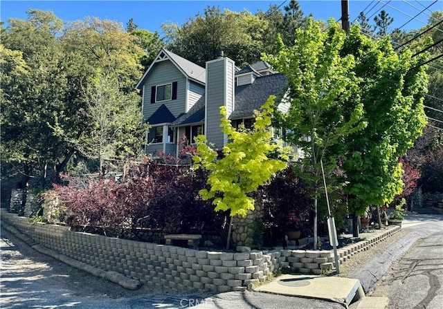 27596 N Bay Rd, Lake Arrowhead, CA 92352 - view of side of property with a chimney and a shingled roof