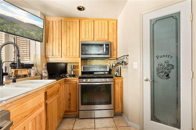 27596 N Bay Rd, Lake Arrowhead, CA 92352 - kitchen with appliances with stainless steel finishes, a sink, and light tile patterned floors