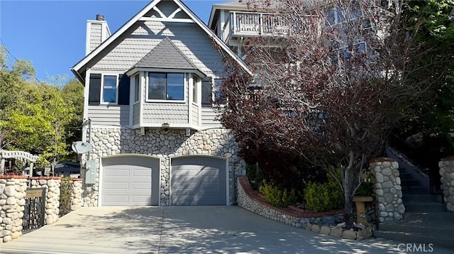 27596 N Bay Rd, Lake Arrowhead, CA 92352 - victorian house featuring a chimney, stone siding, driveway, and a garage