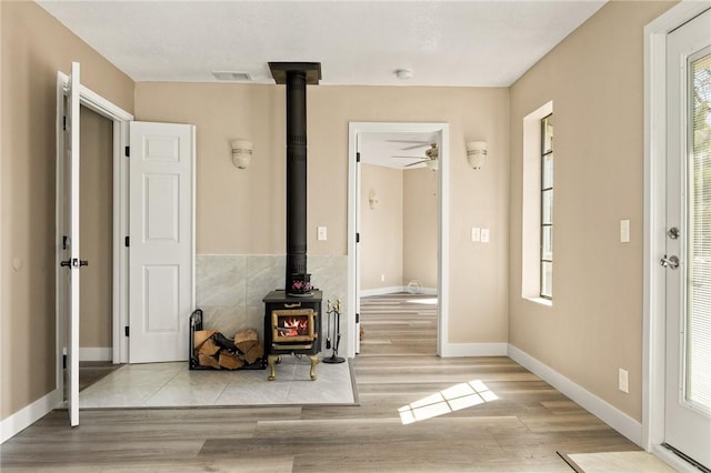 27596 N Bay Rd, Lake Arrowhead, CA 92352 - foyer with a wood stove, a ceiling fan, wood finished floors, and baseboards