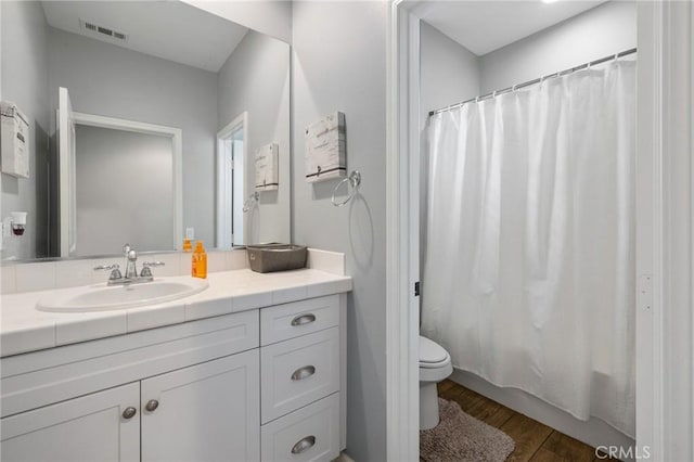 21730 Bene Dr, Saugus, CA 91350 - bathroom featuring vanity, shower / bath combination with curtain, toilet, visible vents, and wood finished floors