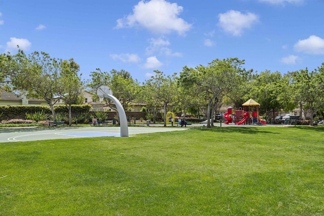view of home's community featuring playground community, a yard, and community basketball court