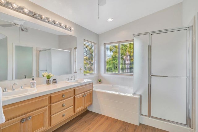 full bathroom featuring a stall shower, vaulted ceiling, ceiling fan, and a sink