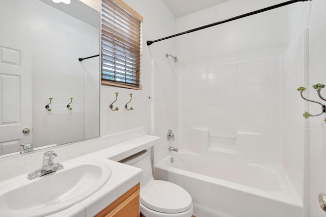 bathroom featuring shower / washtub combination, toilet, and vanity