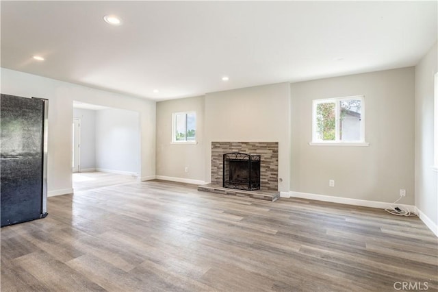 28414 Winterdale Dr, Canyon Country, CA 91387 - unfurnished living room with wood finished floors, a fireplace, and a healthy amount of sunlight