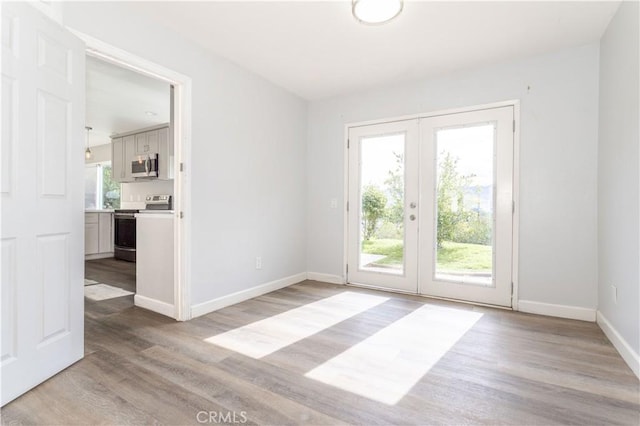28414 Winterdale Dr, Canyon Country, CA 91387 - unfurnished room with light wood finished floors, french doors, and baseboards