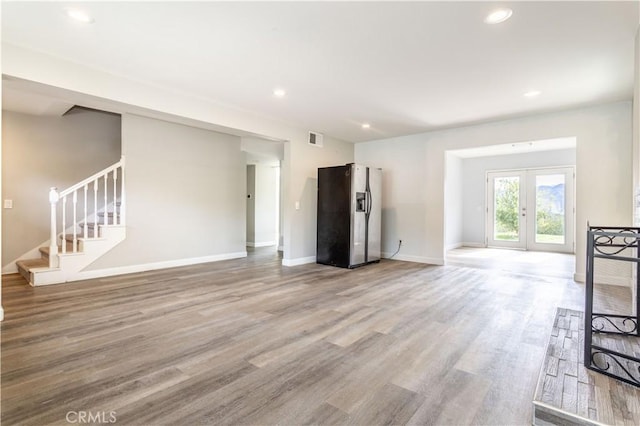 28414 Winterdale Dr, Canyon Country, CA 91387 - unfurnished living room featuring recessed lighting, light wood-style floors, visible vents, and stairs