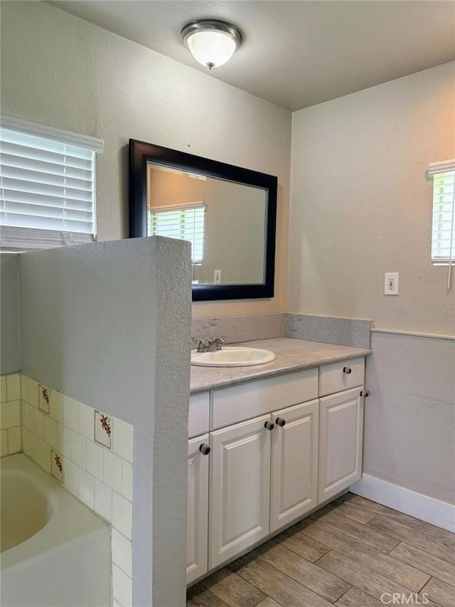 47409 Thunderhill Ln, Squaw Valley, CA 93675 - bathroom with vanity, a garden tub, and wood finished floors