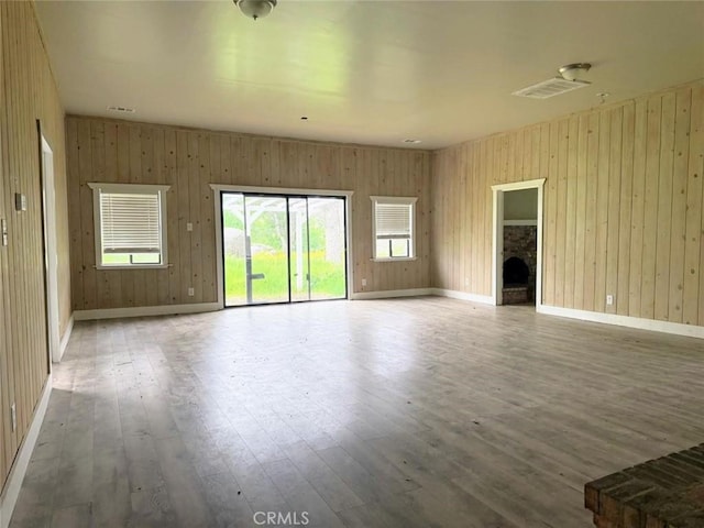 47409 Thunderhill Ln, Squaw Valley, CA 93675 - empty room featuring hardwood / wood-style floors, a fireplace, and wood walls