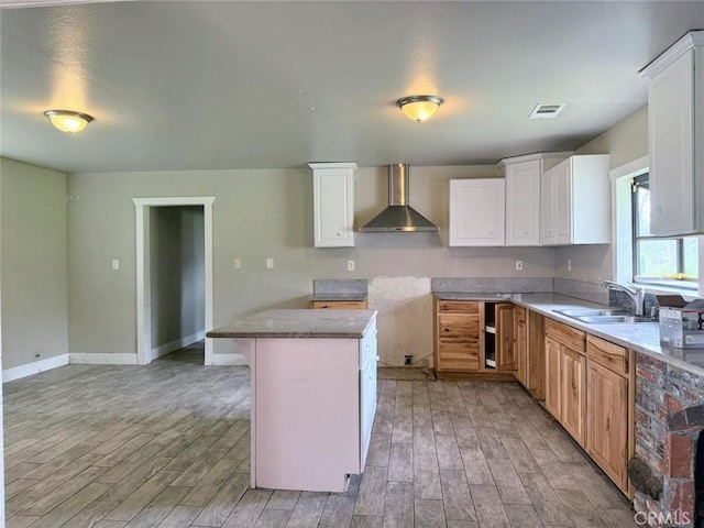 47409 Thunderhill Ln, Squaw Valley, CA 93675 - kitchen featuring wall chimney exhaust hood, light wood-style floors, and white cabinets