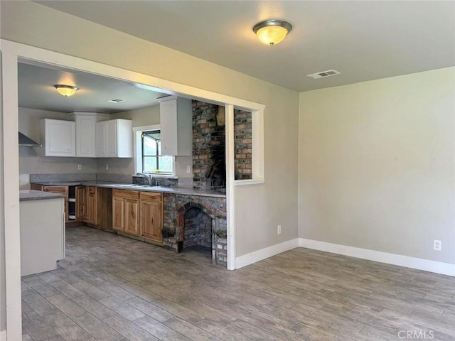 47409 Thunderhill Ln, Squaw Valley, CA 93675 - kitchen with light wood-style flooring, exhaust hood, and white cabinets