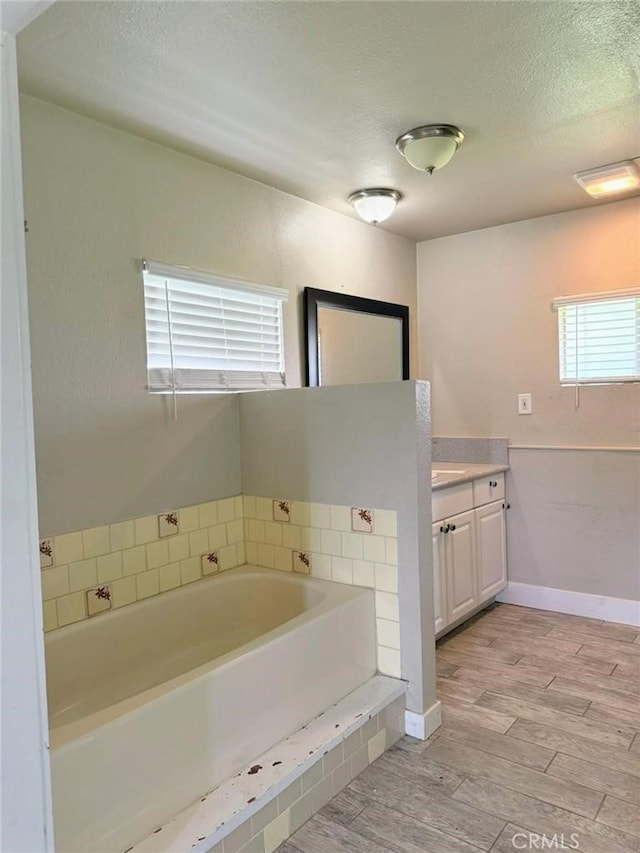 47409 Thunderhill Ln, Squaw Valley, CA 93675 - bathroom featuring vanity, a bath, wood finished floors, and a textured ceiling