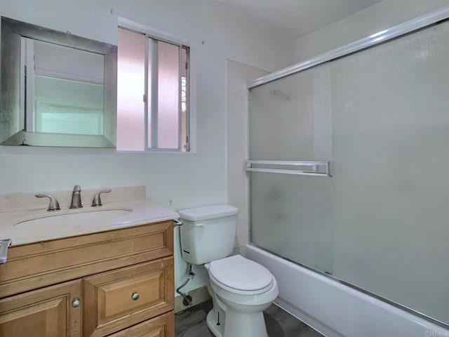 438 S Anza St, El Cajon, CA 92020 - full bath featuring toilet, enclosed tub / shower combo, vanity, and wood finished floors
