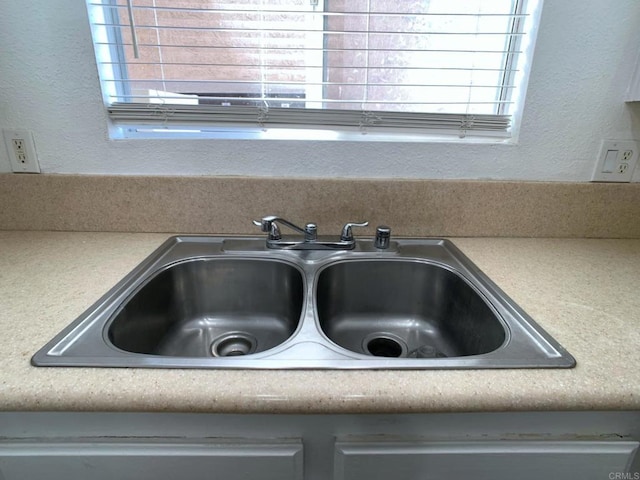 438 S Anza St, El Cajon, CA 92020 - details with a textured wall, light countertops, and a sink
