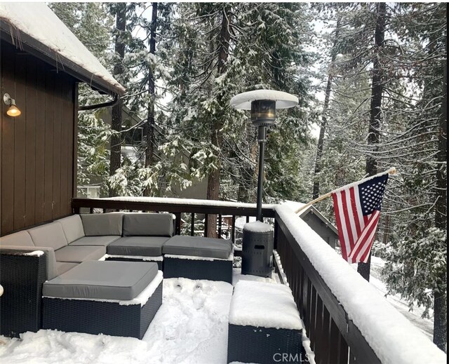 snow covered deck with outdoor lounge area