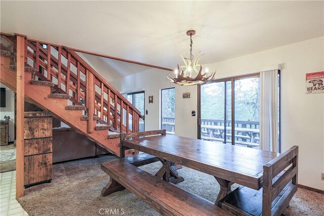 dining room with baseboards, stairs, and a notable chandelier