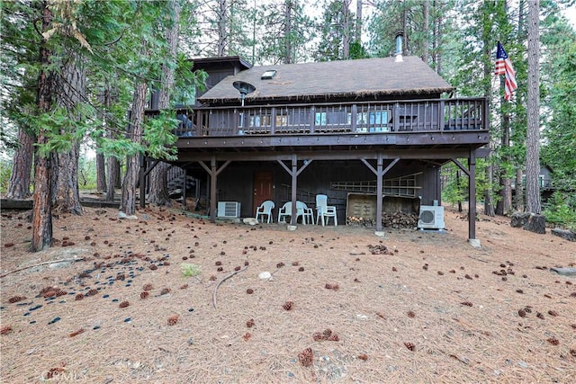 back of house featuring a wooden deck, ac unit, and central AC