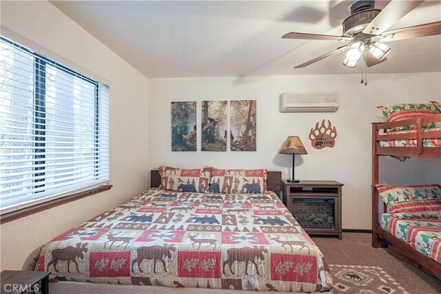 bedroom with carpet floors, an AC wall unit, and ceiling fan