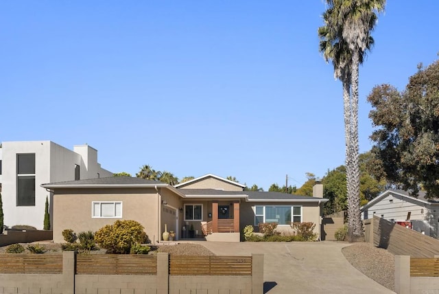 2422 Chatsworth Blvd, Point Loma, CA 92106 - view of front of home featuring stucco siding, an attached garage, a fenced front yard, and concrete driveway