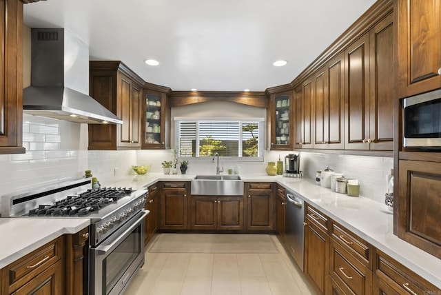 2422 Chatsworth Blvd, Point Loma, CA 92106 - kitchen with light countertops, a sink, appliances with stainless steel finishes, glass insert cabinets, and wall chimney range hood