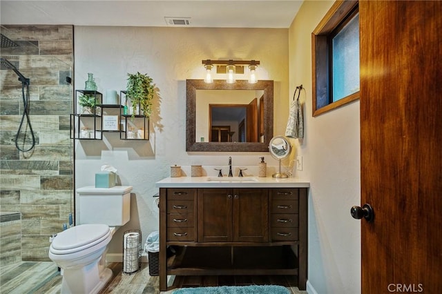 31353 Lightfoot Way, Running Springs, CA 92382 - bathroom featuring vanity, a tile shower, and wood finished floors
